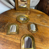 Set of five small wall mirrors in brass.