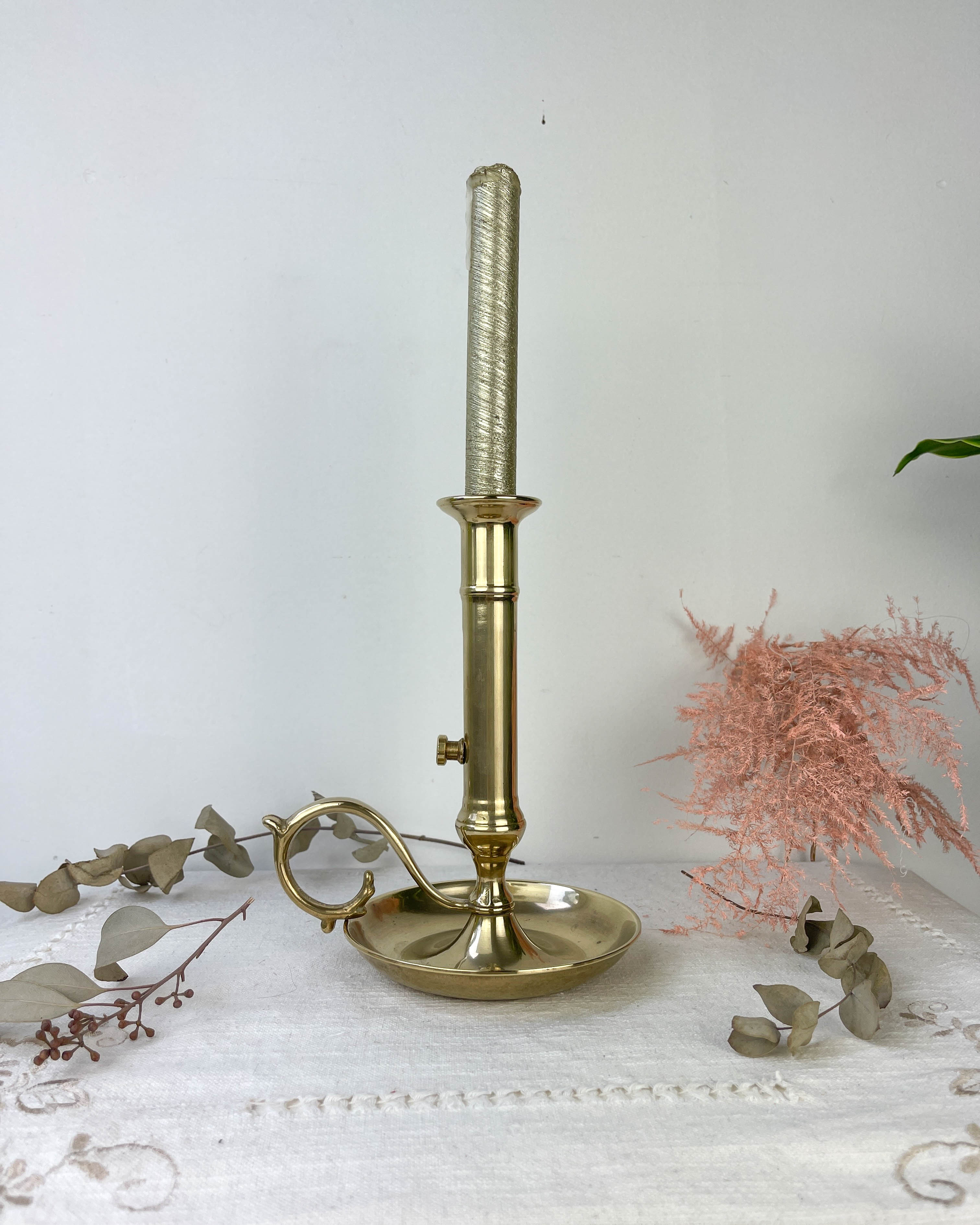 Brass candle holder with pusher late nineteenth century