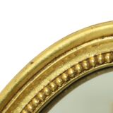 Miroir ovale doré de style Hollywood Regency