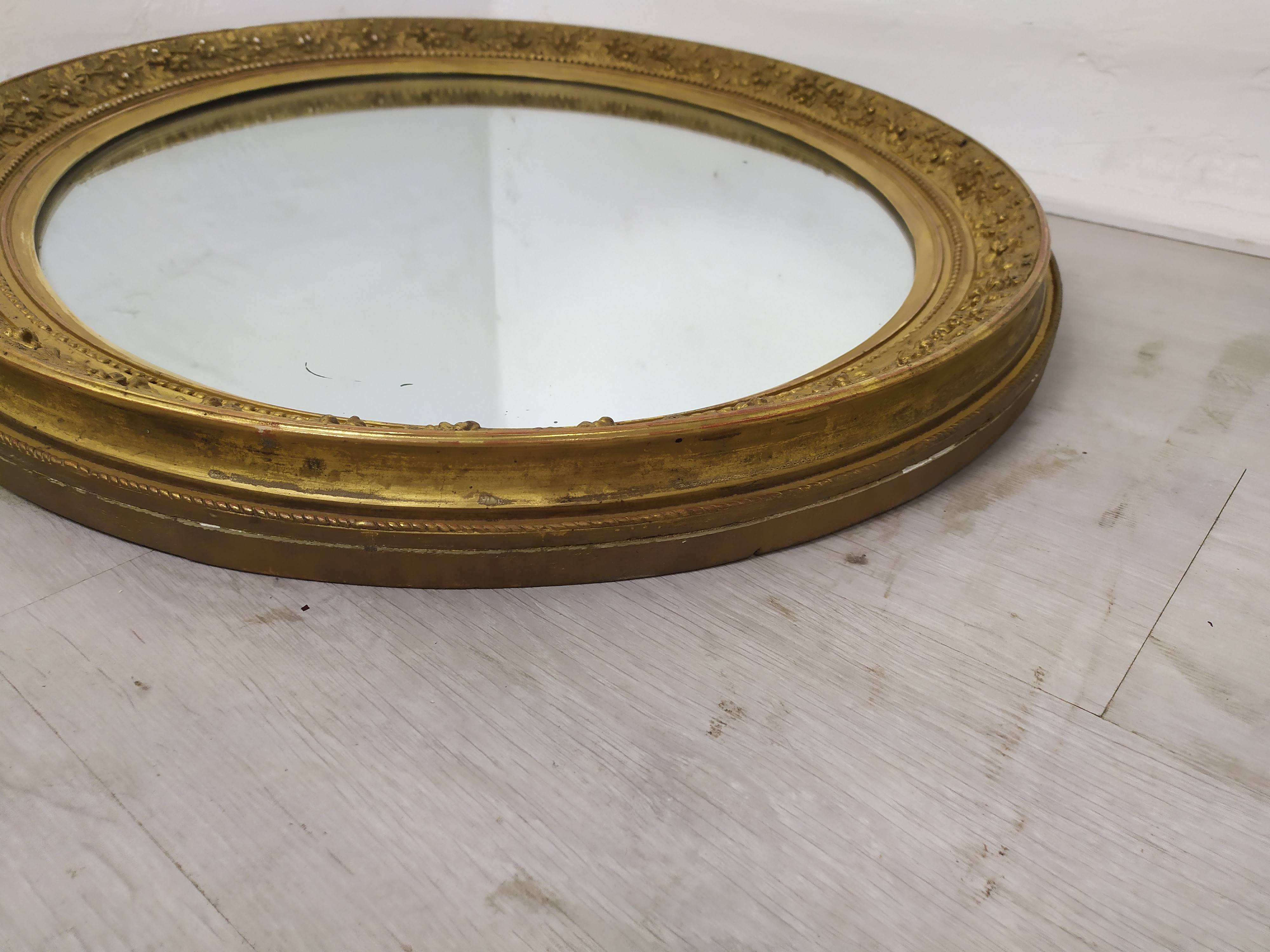 Golden oval mirror