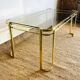 Gold metal and smoked glass coffee table – 1970s-624001