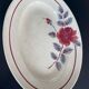 Oval plate Moulin des Loups in blue and red ceramic with a floral design.