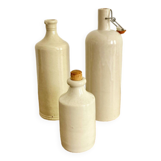 Trio of creamy white glazed stoneware bottles