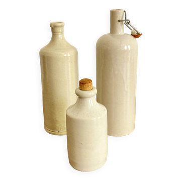 Trio of creamy white glazed stoneware bottles