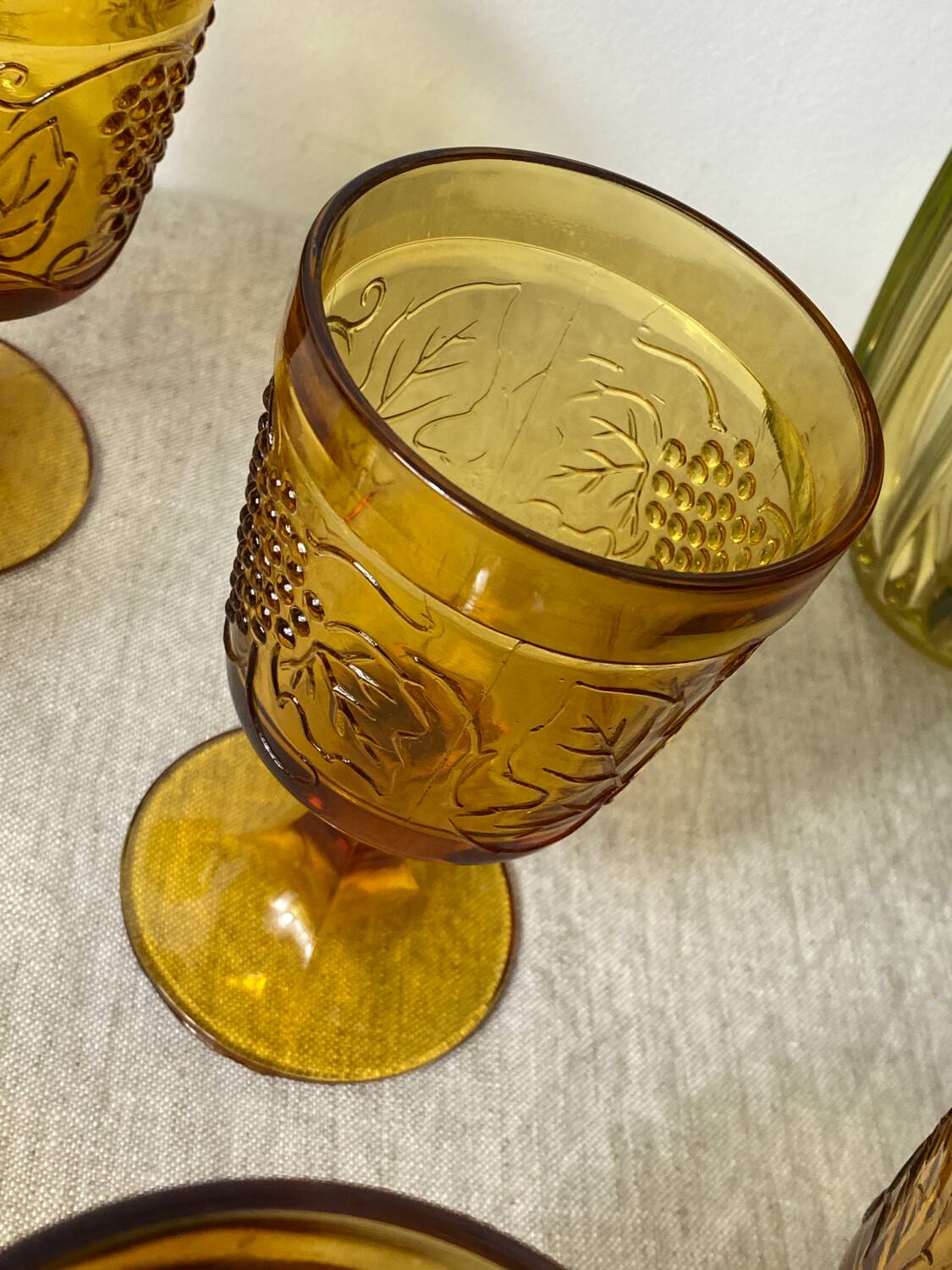 Six amber-colored stemmed glasses