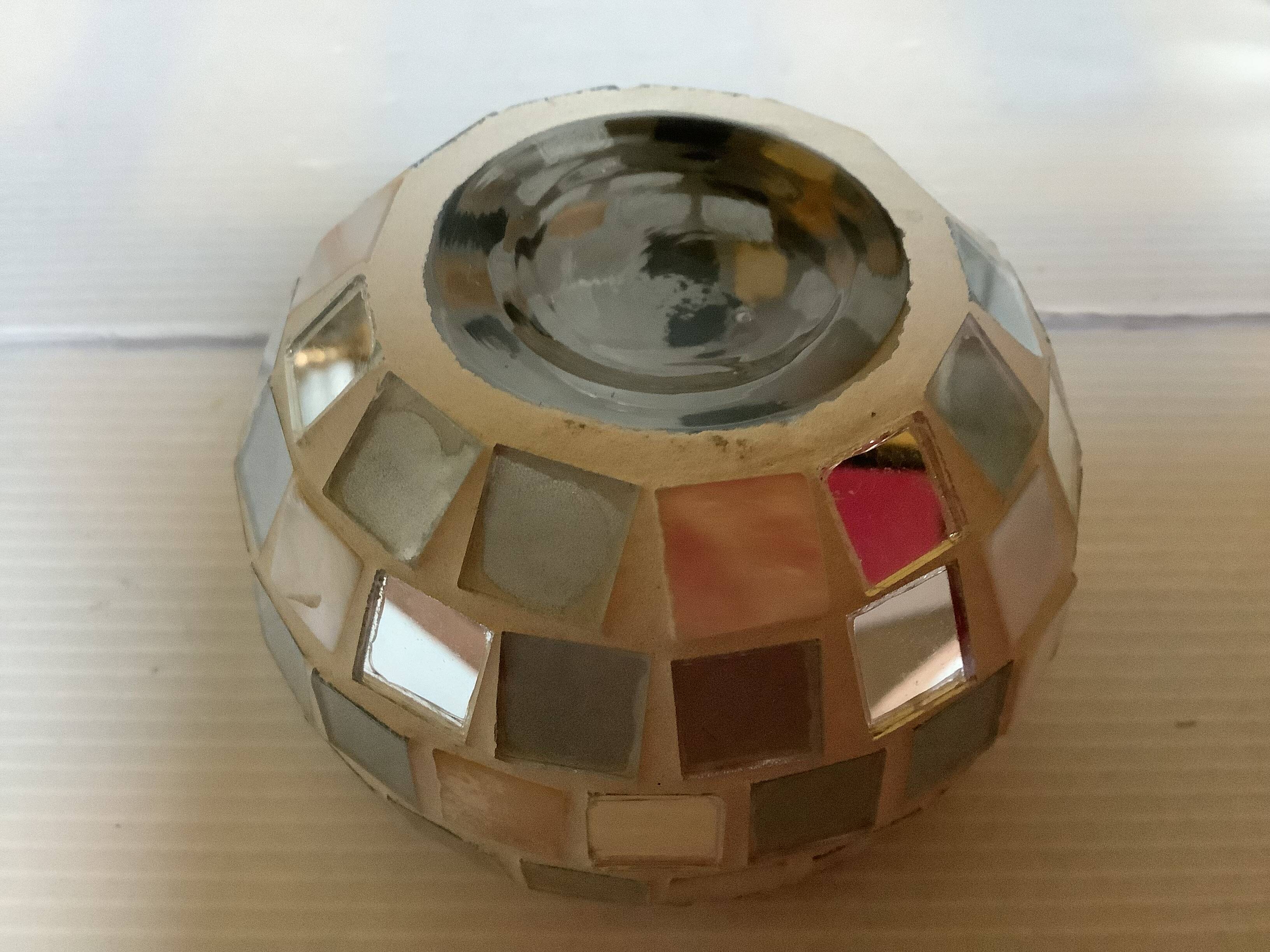 Four mosaic mirror and mother-of-pearl candle holders.