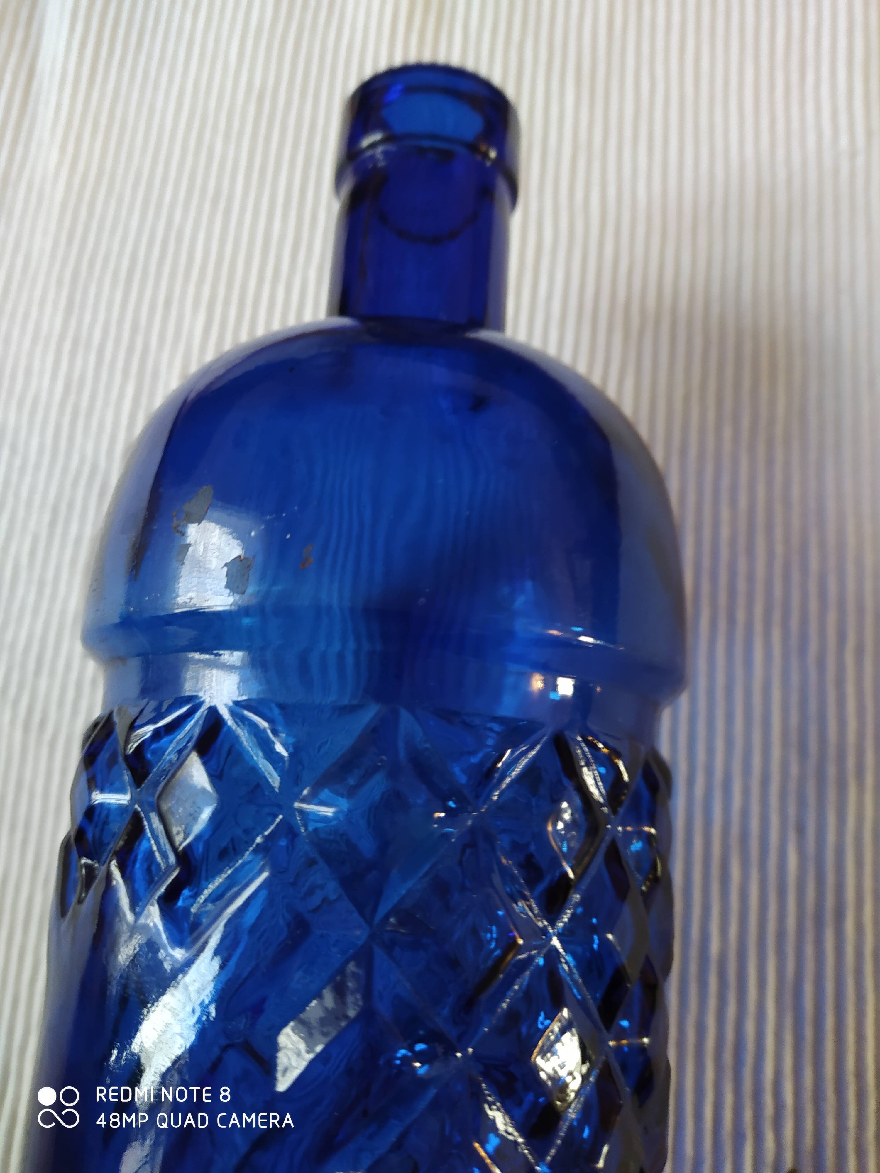 Vintage bottle in chiseled blue glass