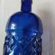 Vintage bottle in chiseled blue glass