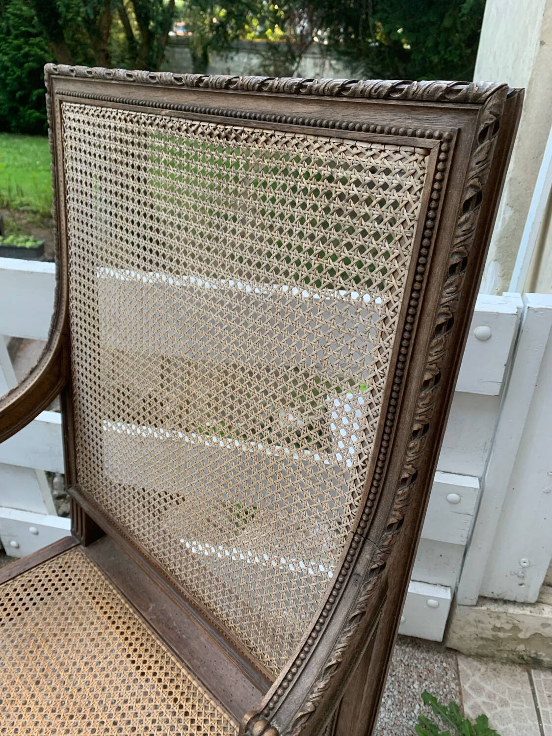 Wooden armchair with caning in Louis XVI style