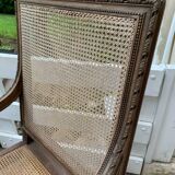 Wooden armchair with caning in Louis XVI style
