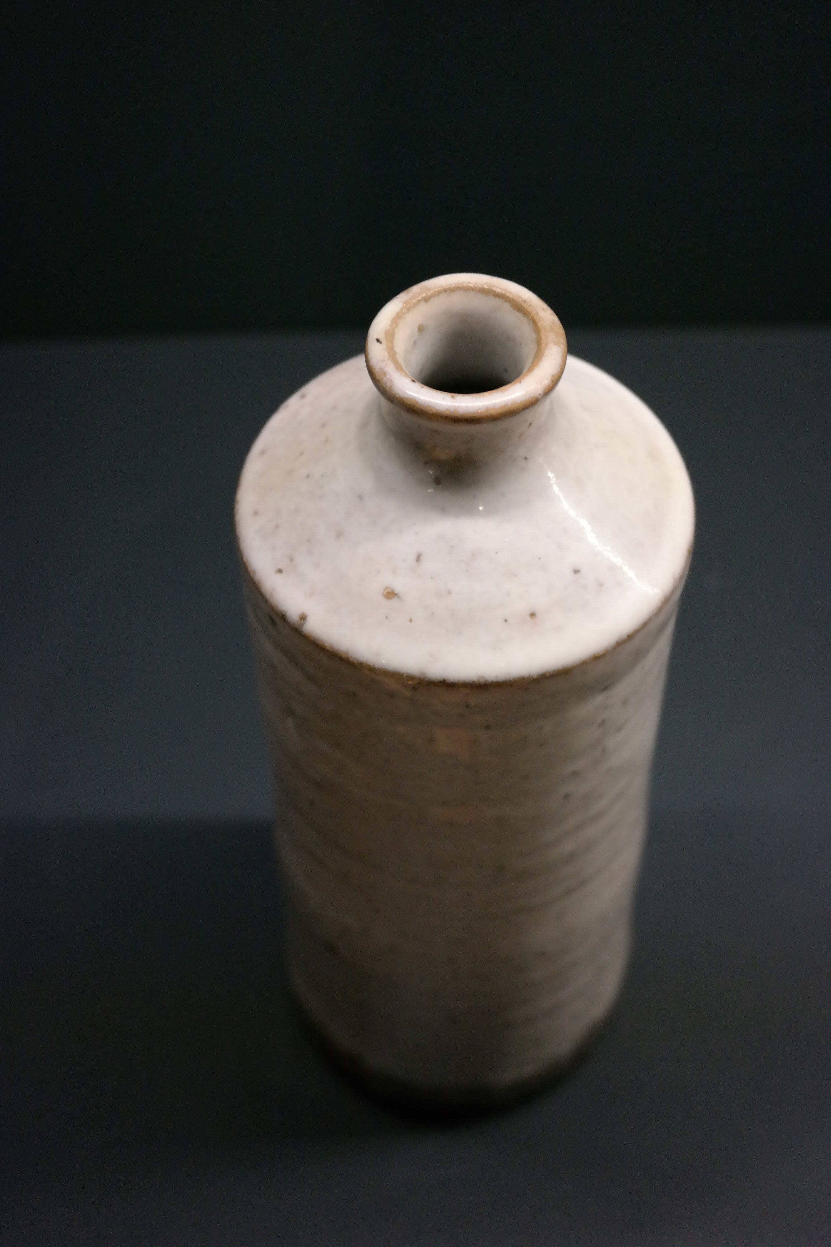 White enamelled sandstone bottle-shaped vase