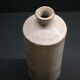 White enamelled sandstone bottle-shaped vase