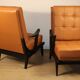 Paire de fauteuils vintage années 50 en bois noir et cuir caramel