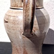 Stoneware water jug, owl decoration, signature to be identified.