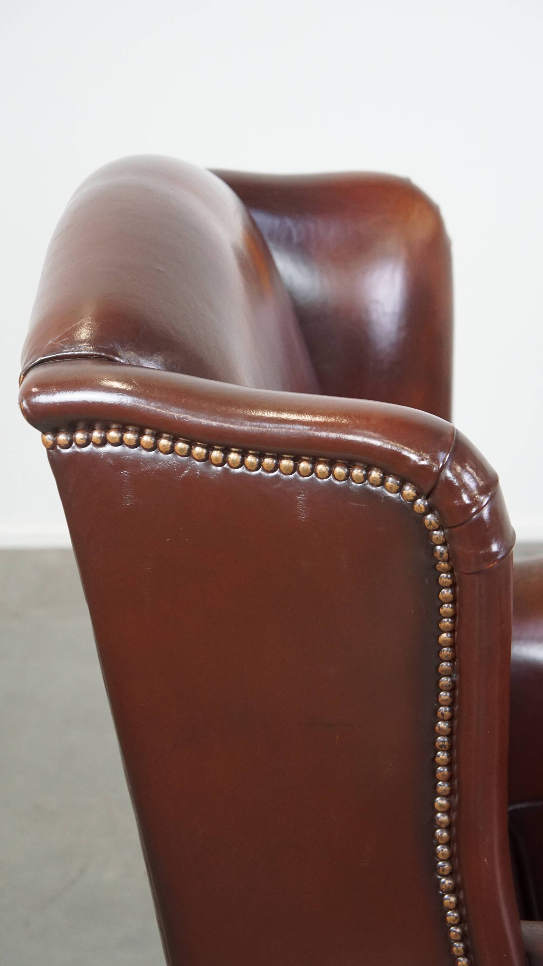 Dark English style sheepskin wingback chair with character and patina