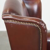 Dark English style sheepskin wingback chair with character and patina