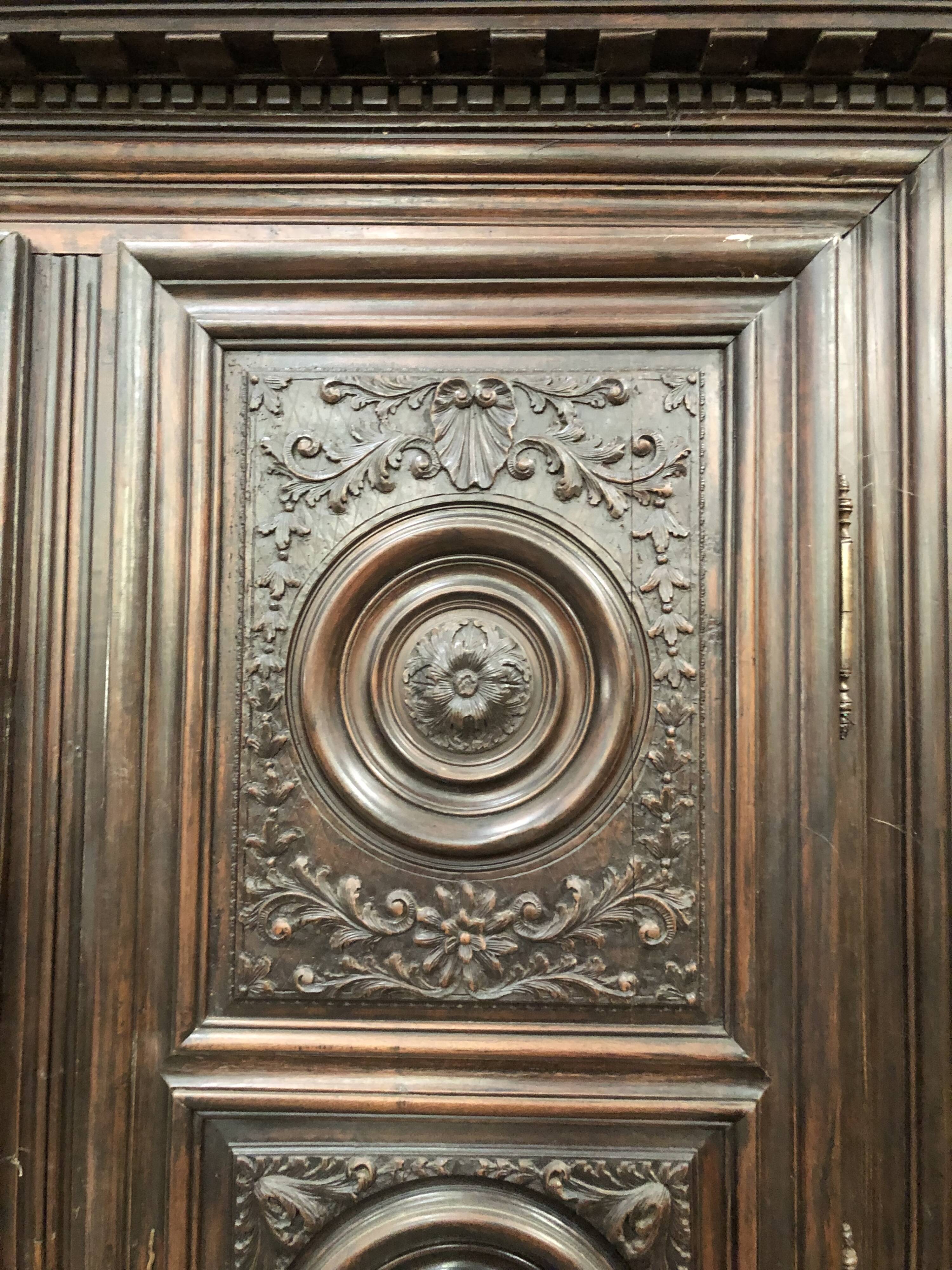 Antique Louis XIII armoire in solid walnut with carved doors