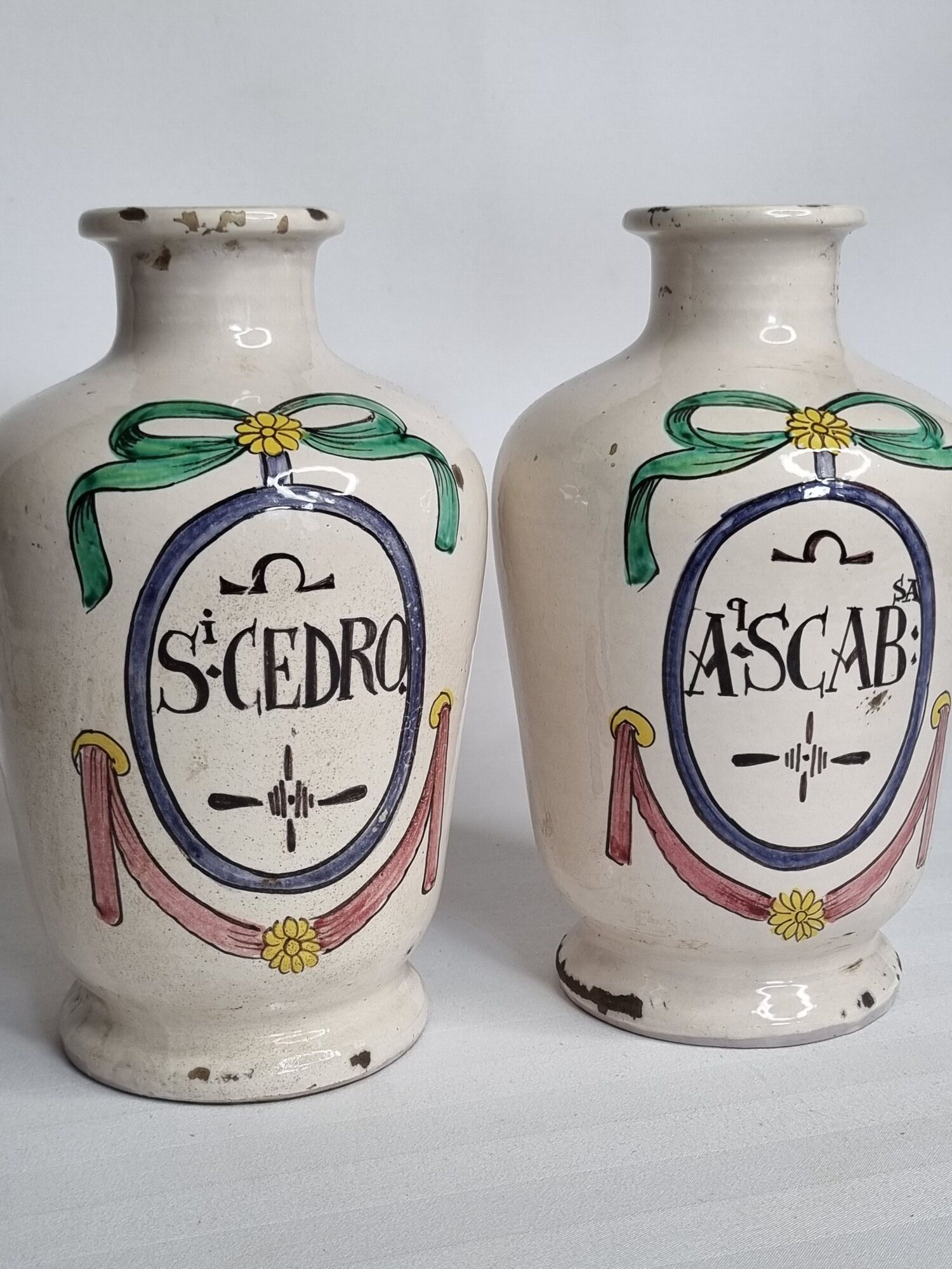 Pair of antique apothecary pots in glazed ceramic, decorated by hand