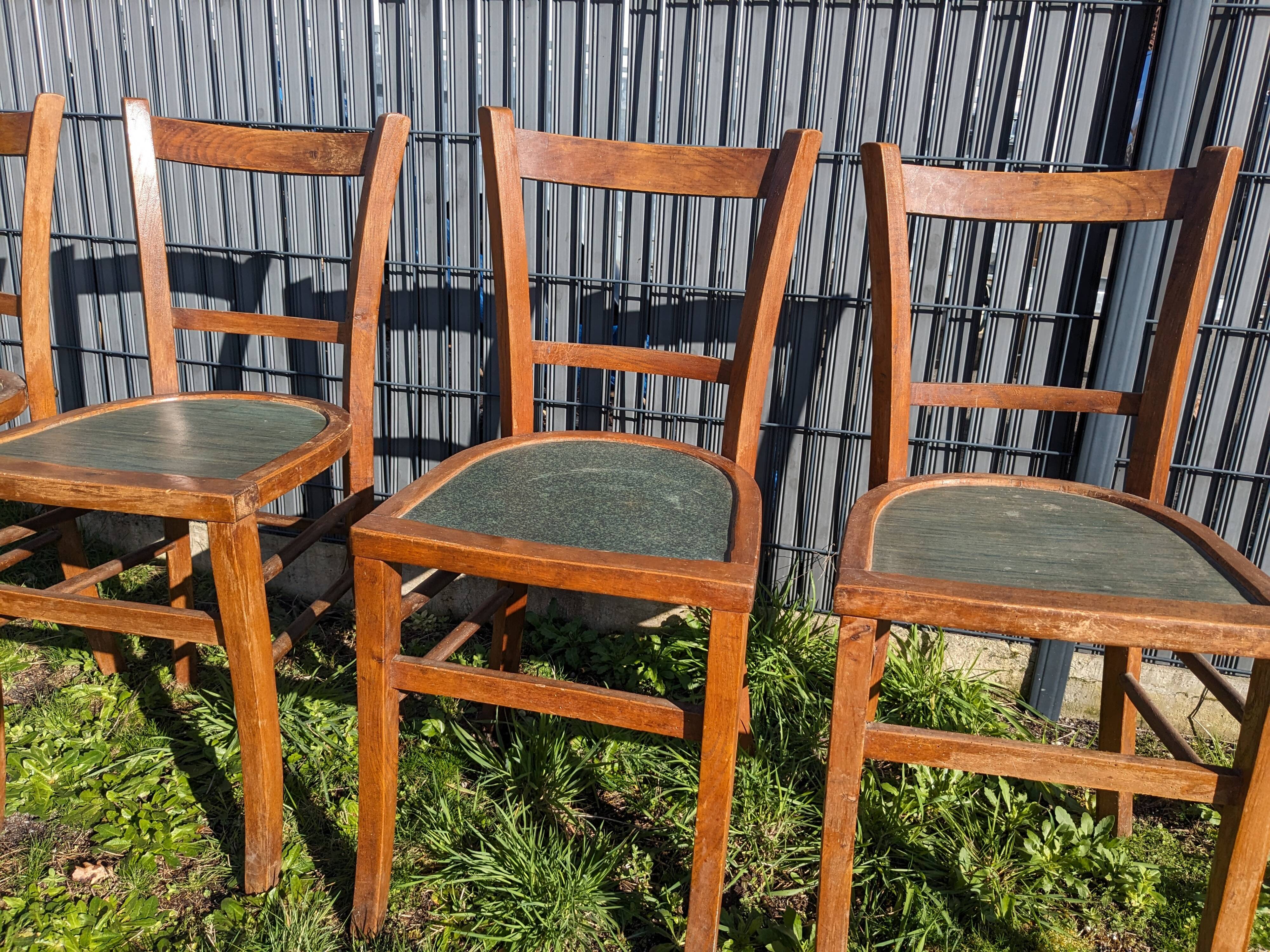 Set of four wooden bistro chairs, green seat, mid-20th century.