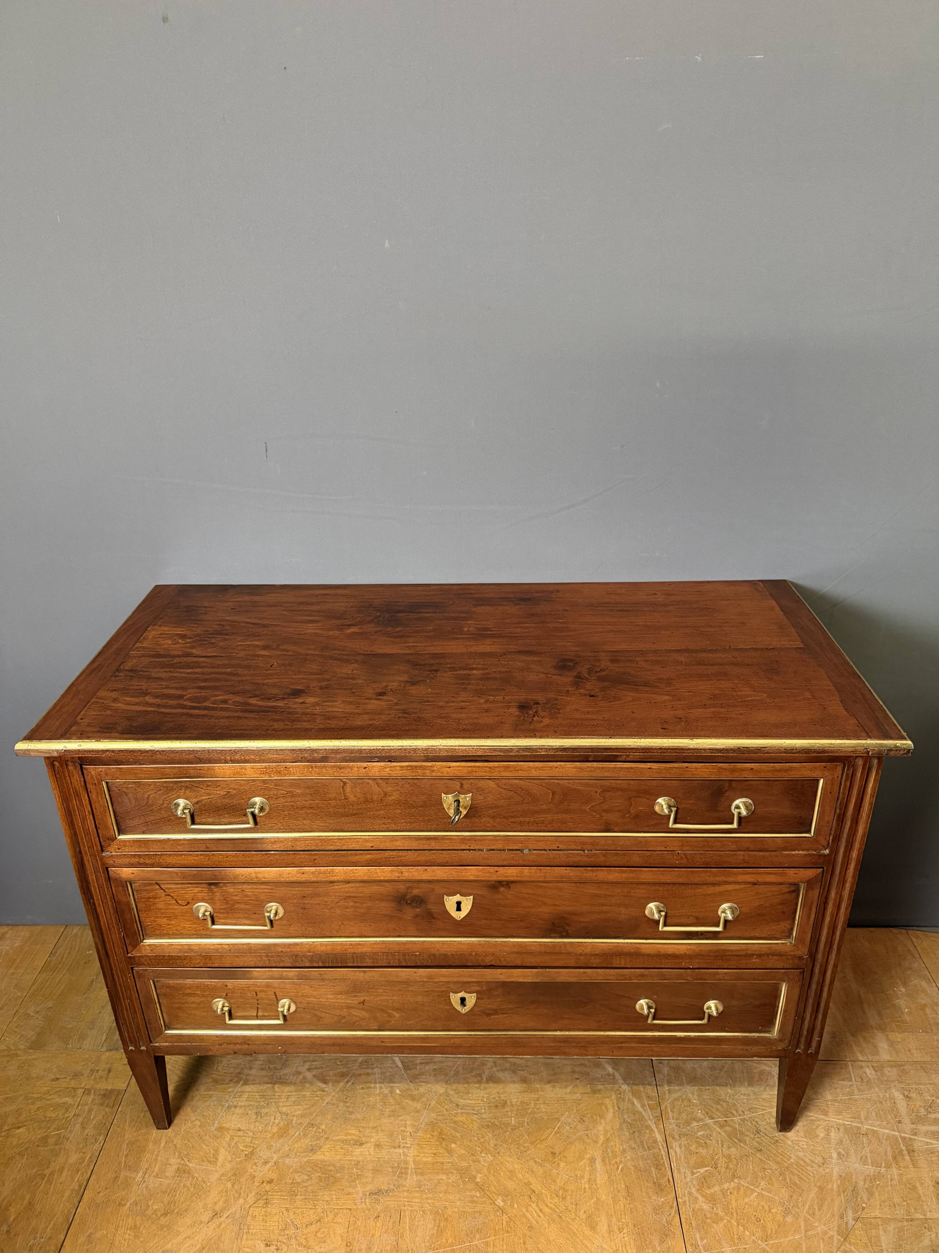 Louis XVI commode in walnut, beech, and brass.