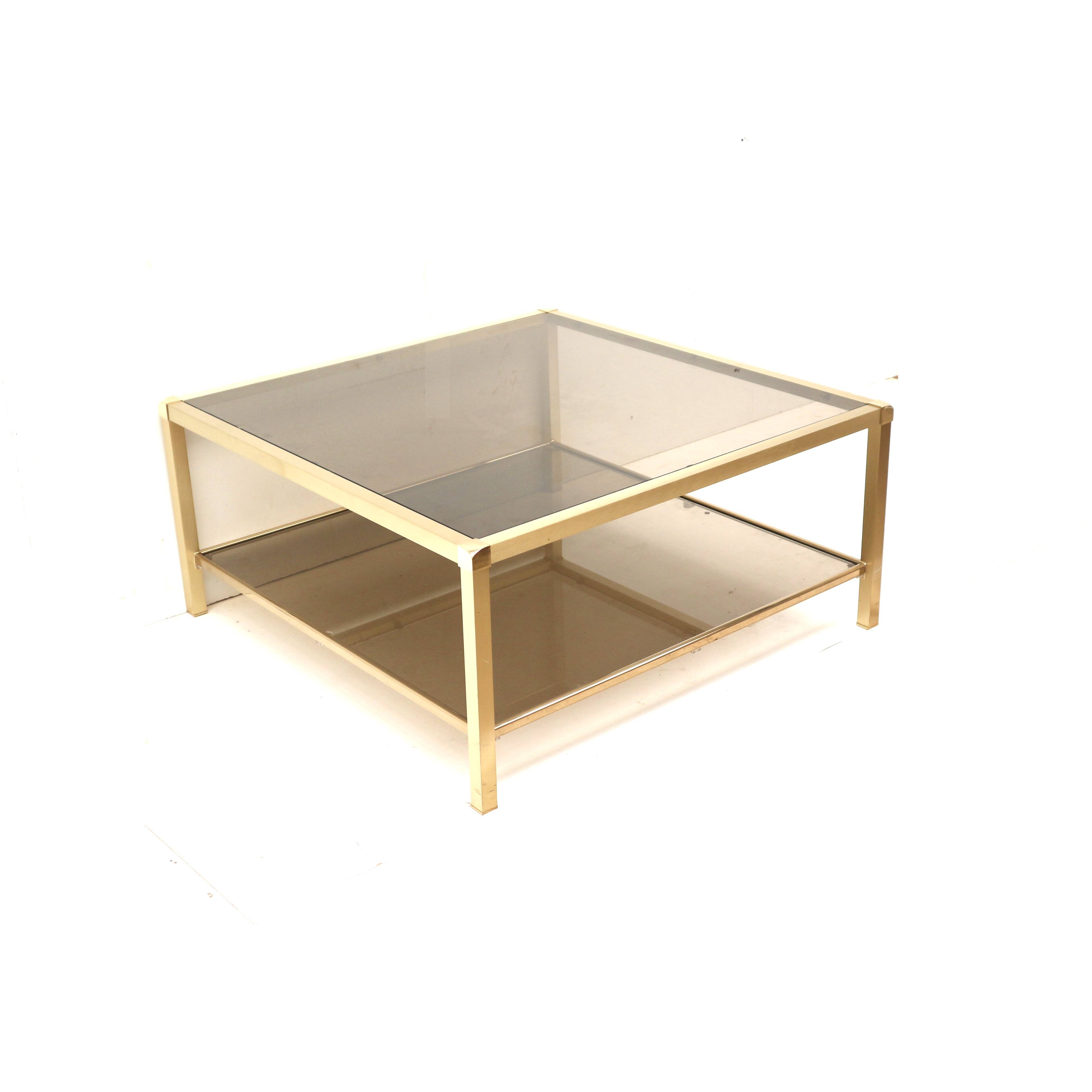 Large vintage Hollywood Regency coffee table made of brass and smoked glass from the 1970s