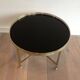 Round coffee table in brass with a black lacquered glass top by Maison Jansen.