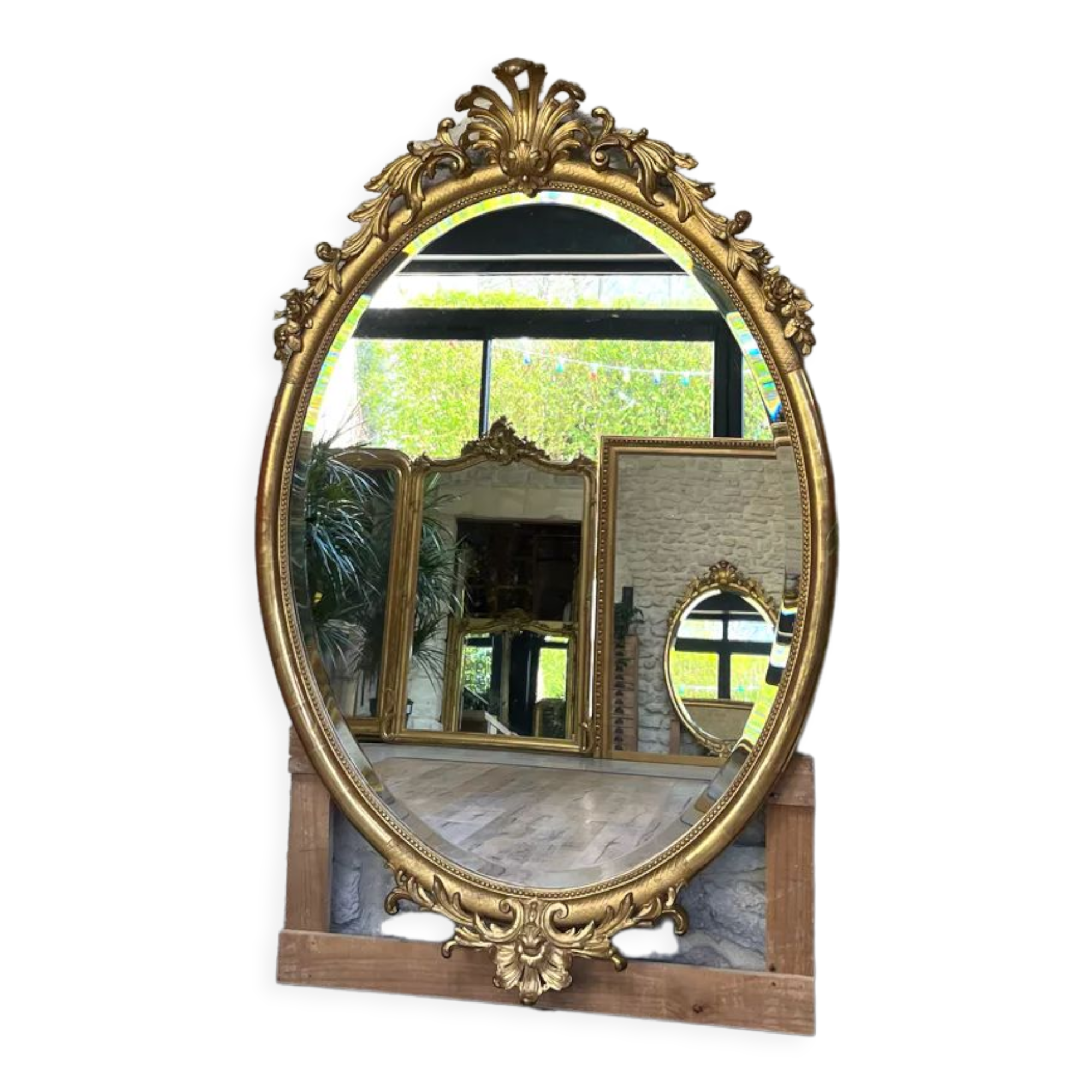 Oval mirror with pediment, beaded gilded with gold leaf