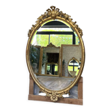 Oval mirror with pediment, beaded gilded with gold leaf