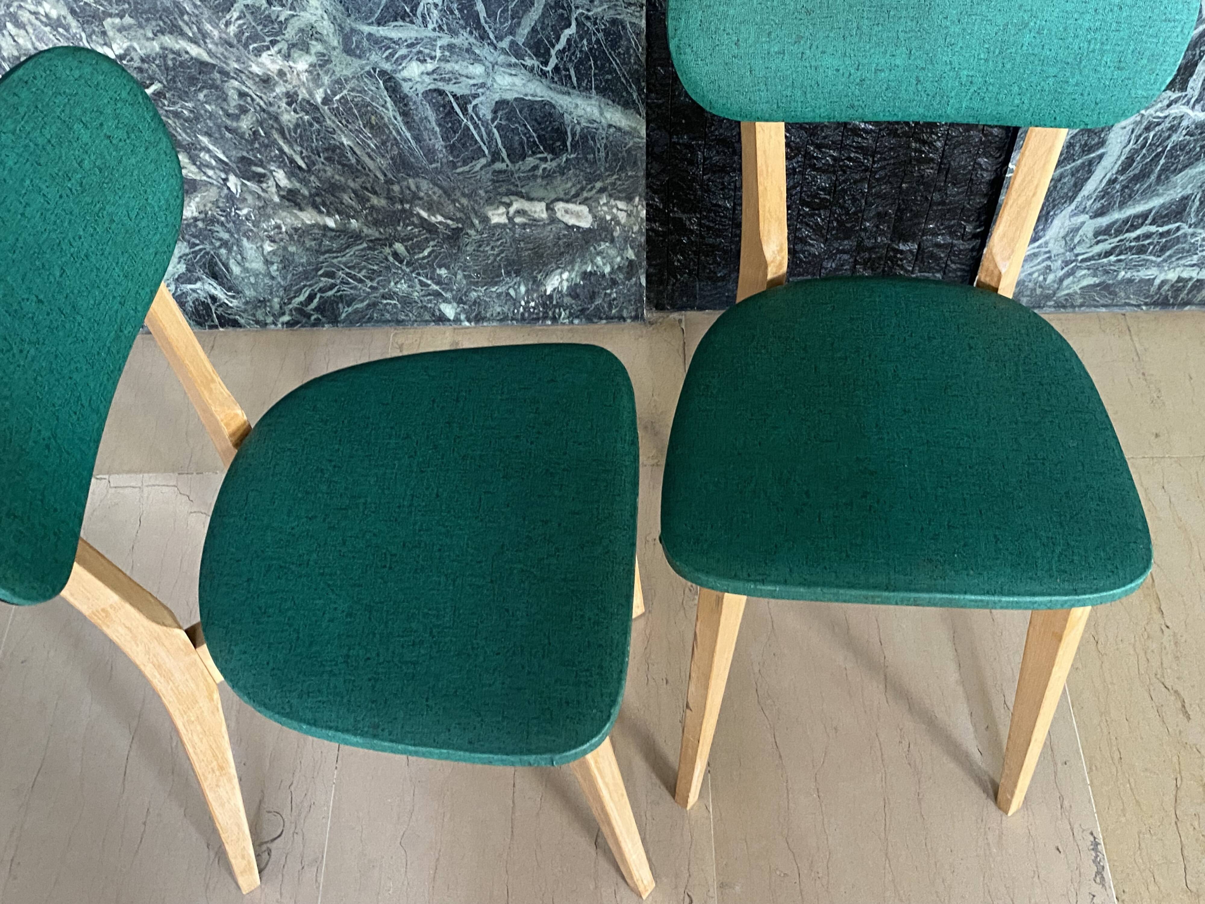 Paire de chaises vintage skaï vert pieds compas