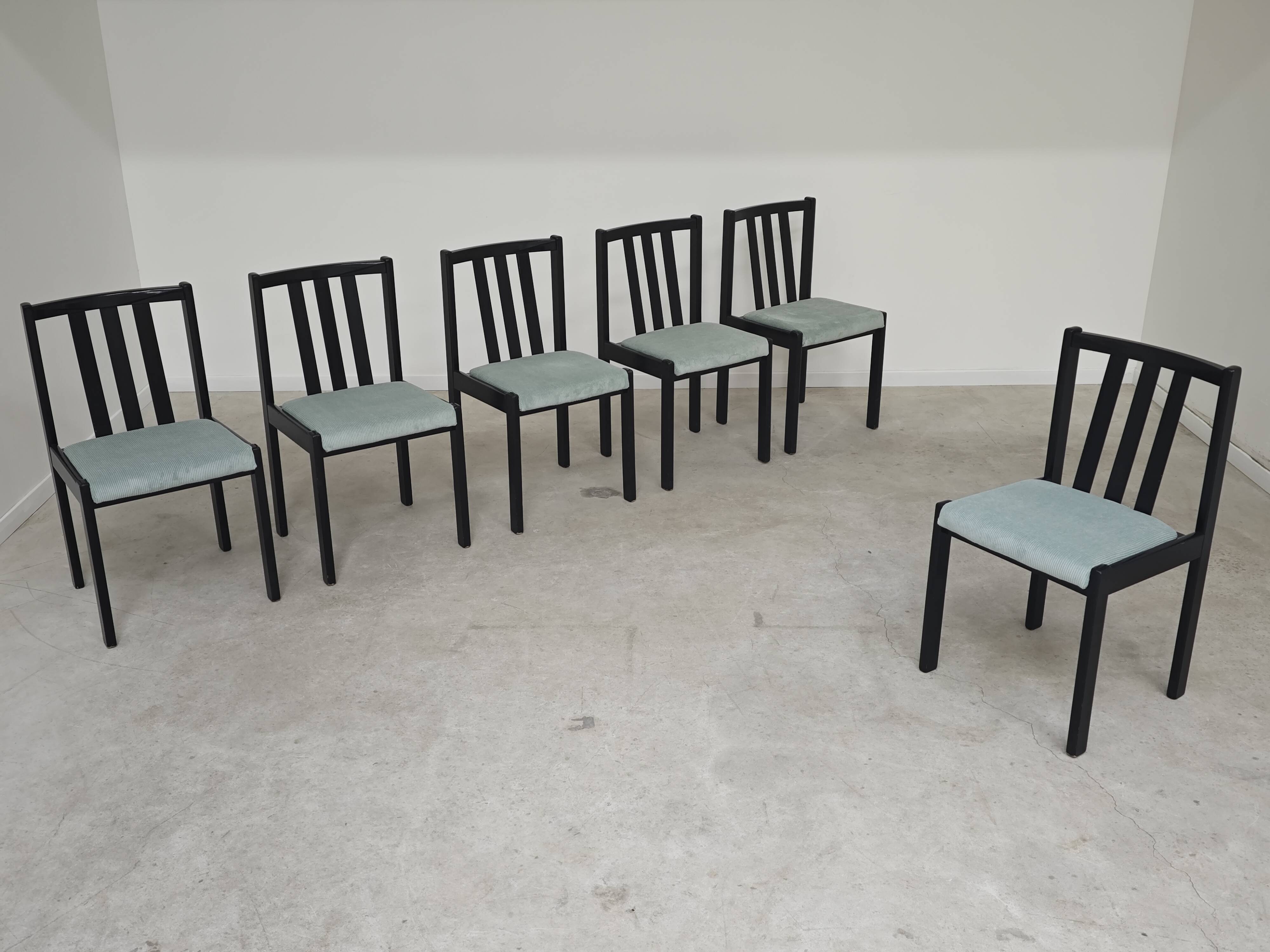 Set of 6 modernist black chairs with light blue-green ribbed fabric.