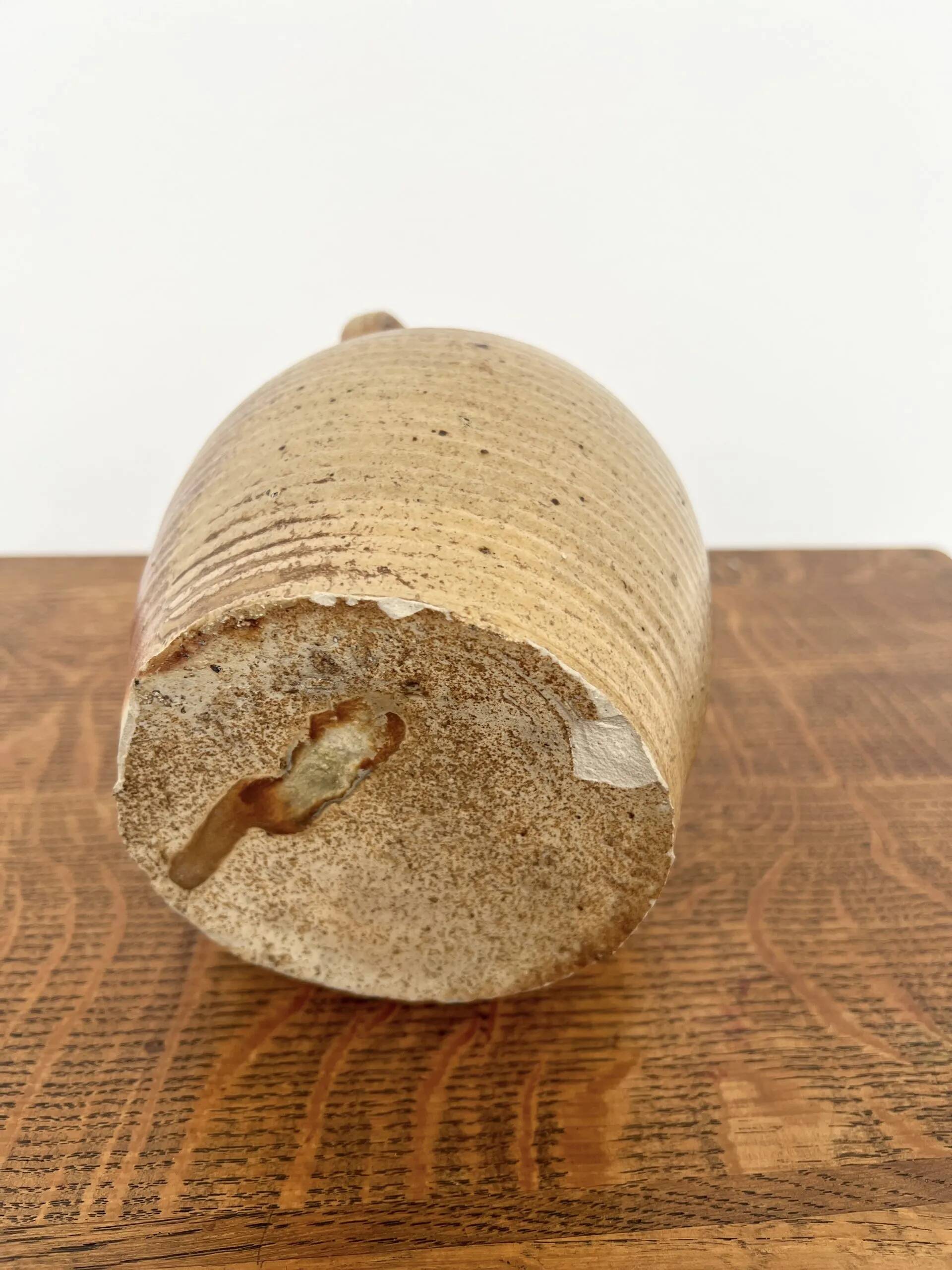 Small antique stoneware jar with handle