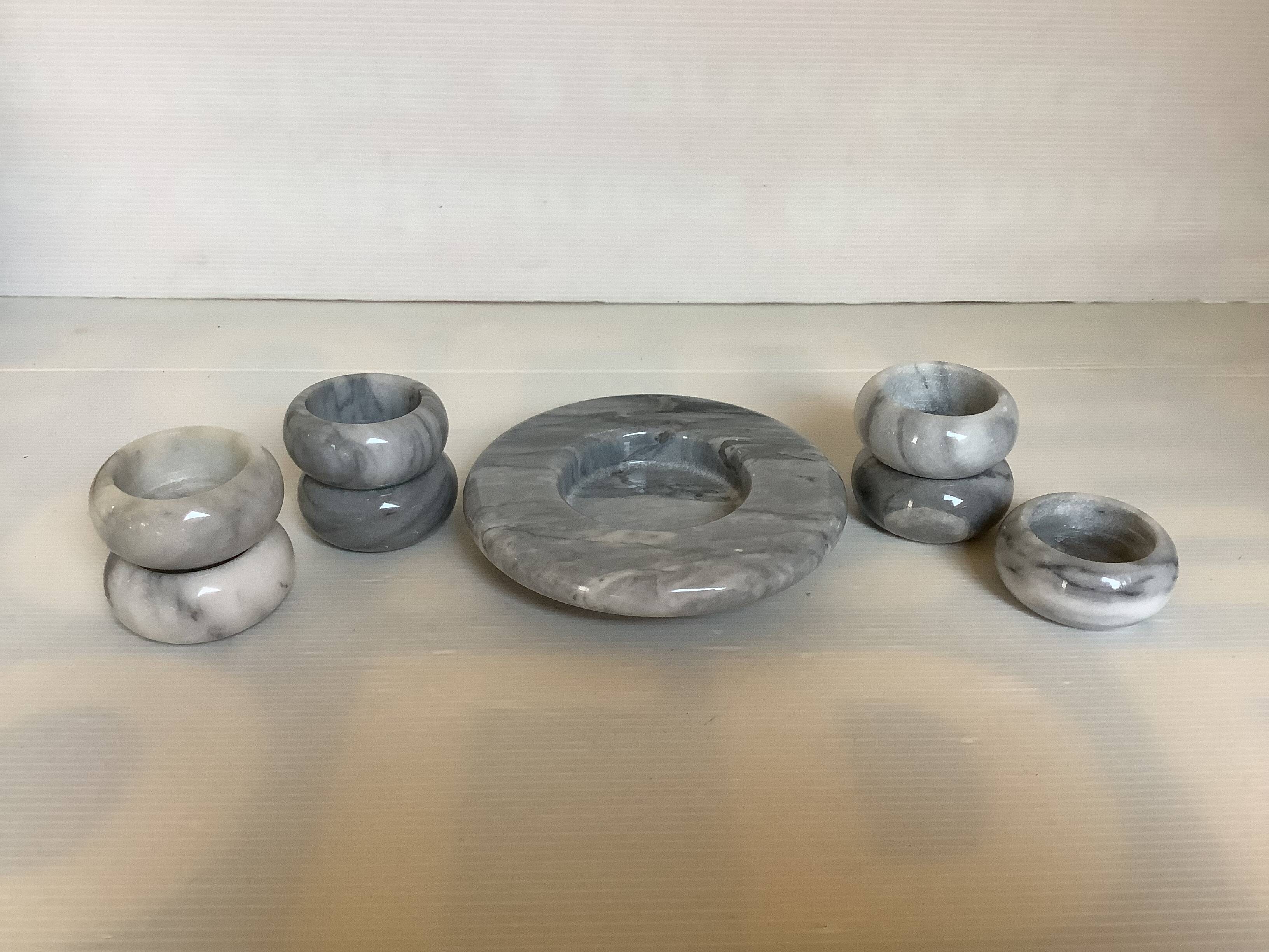 Eight grey-white marble candlesticks