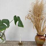Old golden brass candle holder in the shape of a leaf or flower