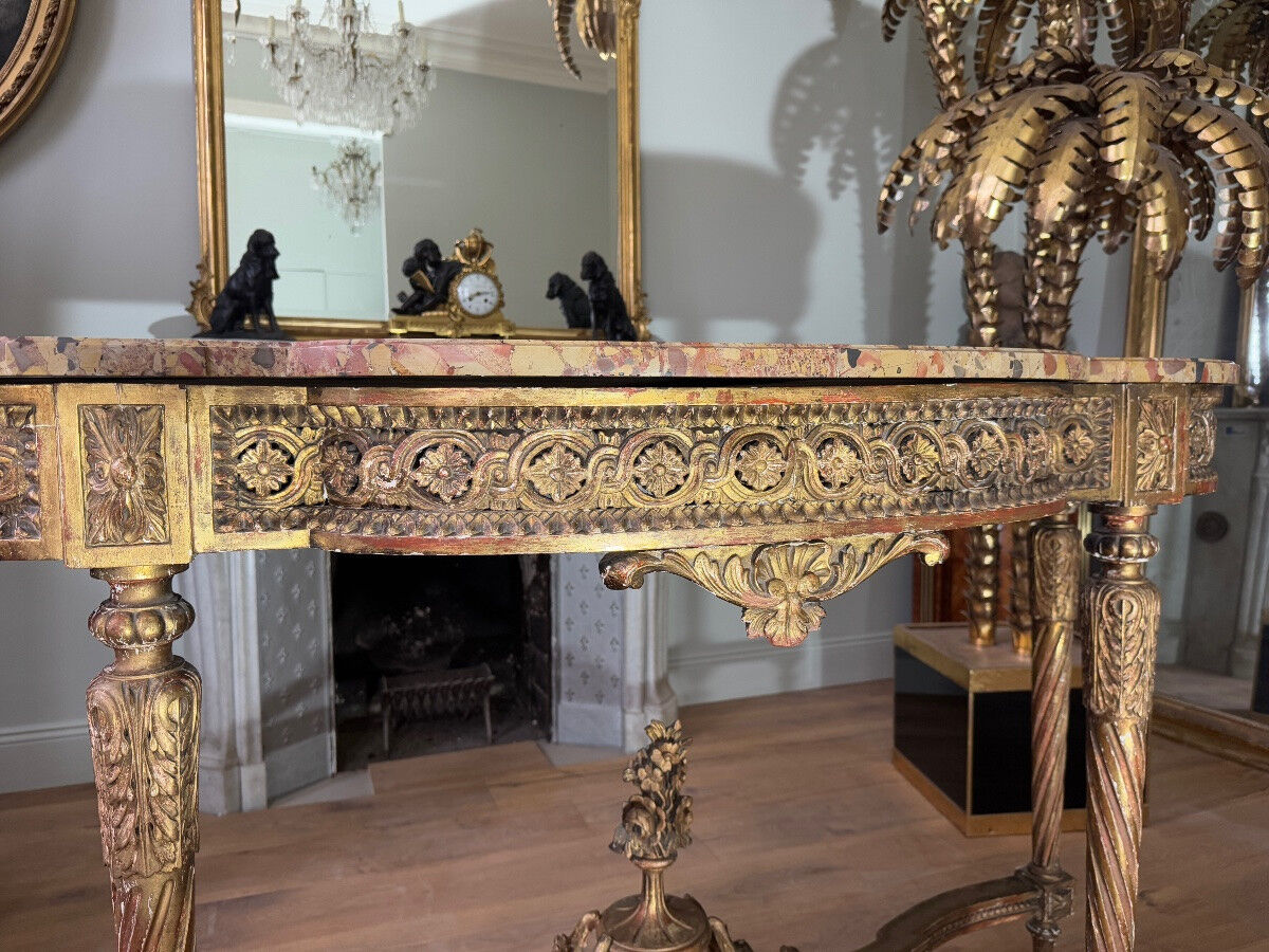 Console with 4 legs from the end of the 19th century in gilded wood in the Louis XVI style.