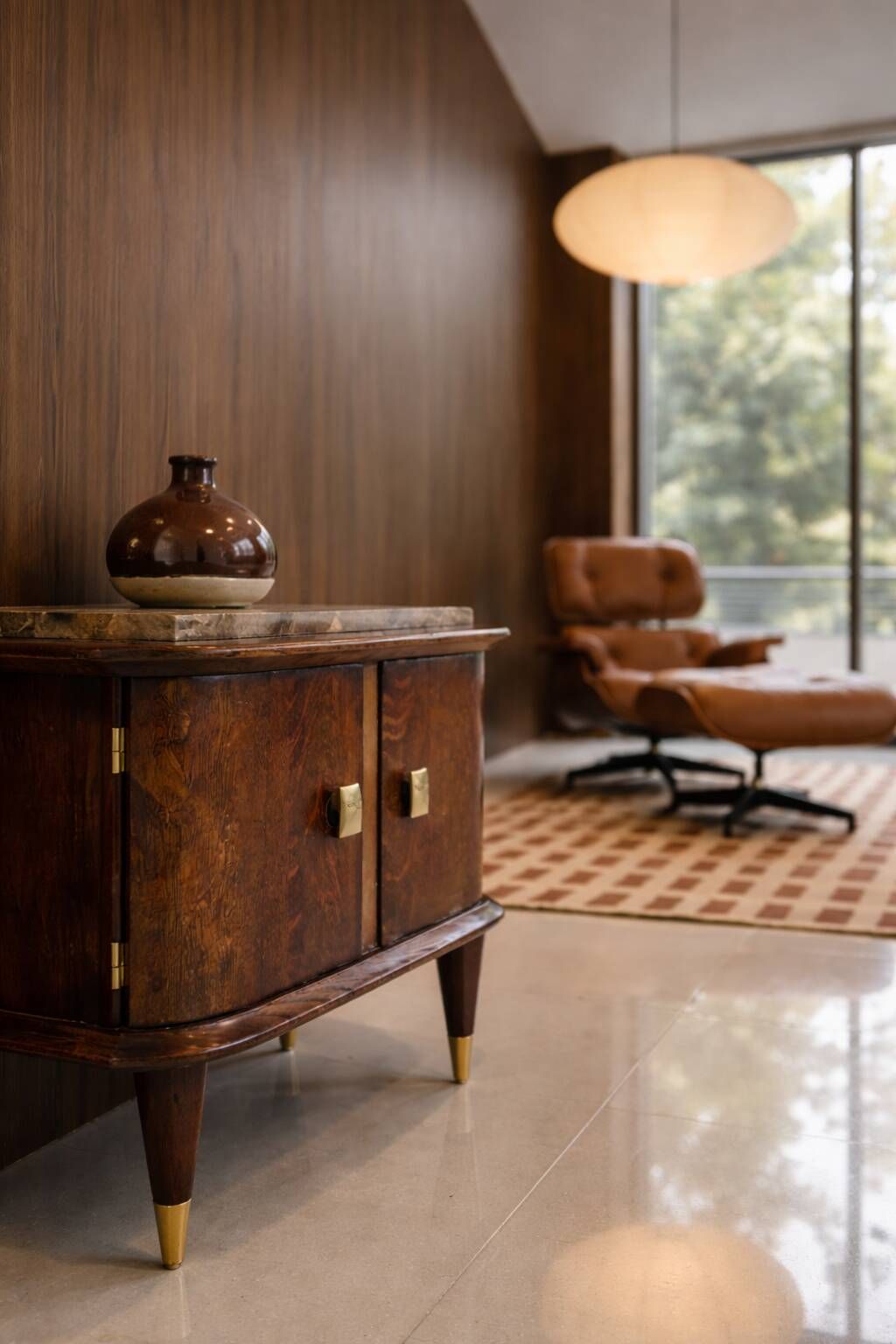 Small vintage 1950s wooden buffet with marble top and tapered legs.