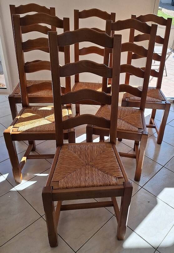 Set of 6 solid oak chairs with straw seats.
