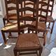 Set of 6 solid oak chairs with straw seats.
