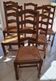 Set of 6 solid oak chairs with straw seats.