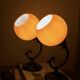Pair of wall sconces with orange opaline globes and porcelain rose.