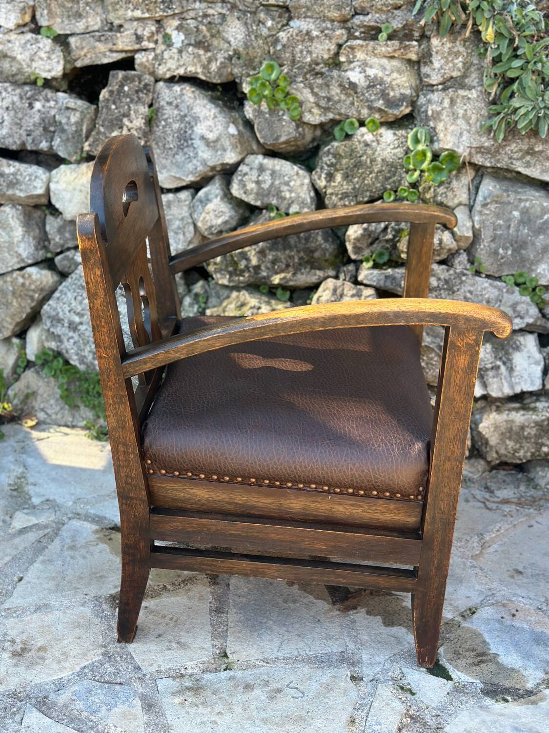 Pair of armchairs in stained wood and leather, 20th century