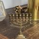 Chandelier, seven-branched menorah, in brass.