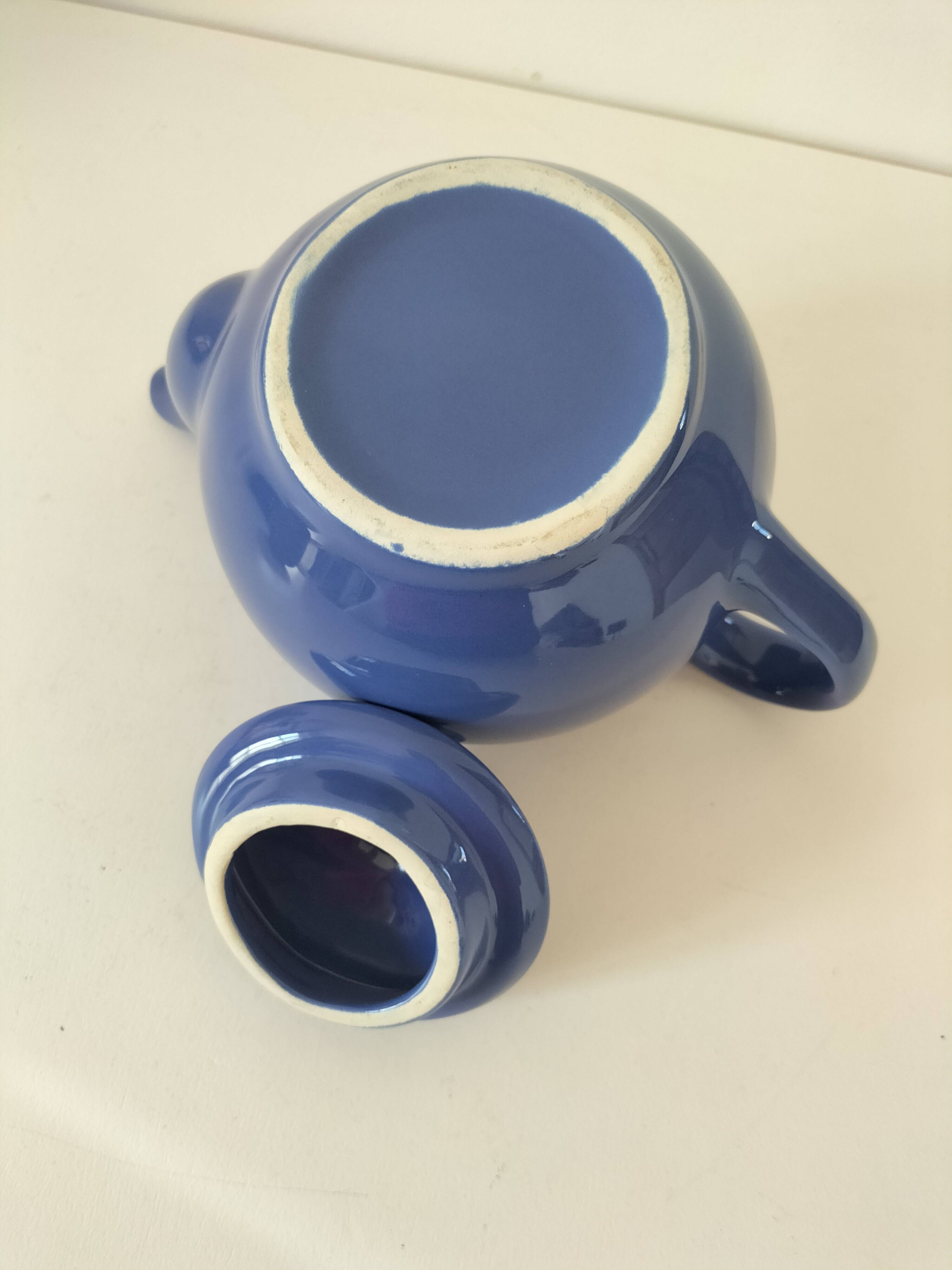 Vintage deep blue teapot, minimalist round shape.