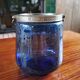 Old ice or biscuit bucket made of golden decor blue glass