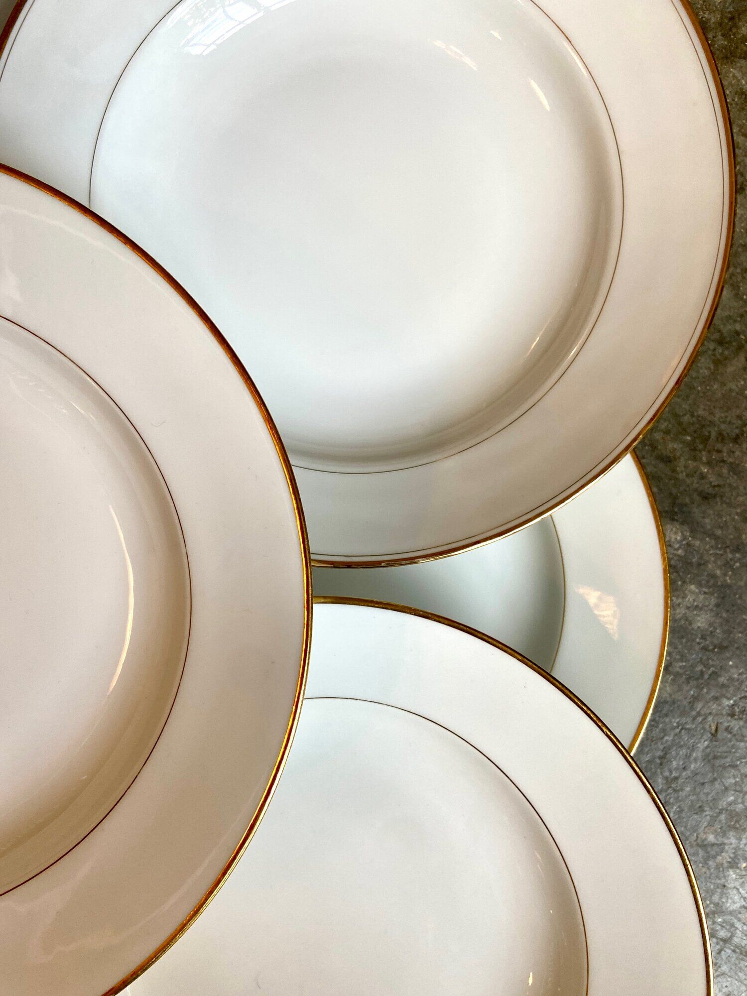 9 hollow plates in white and golden Limoges porcelain