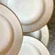 9 hollow plates in white and golden Limoges porcelain