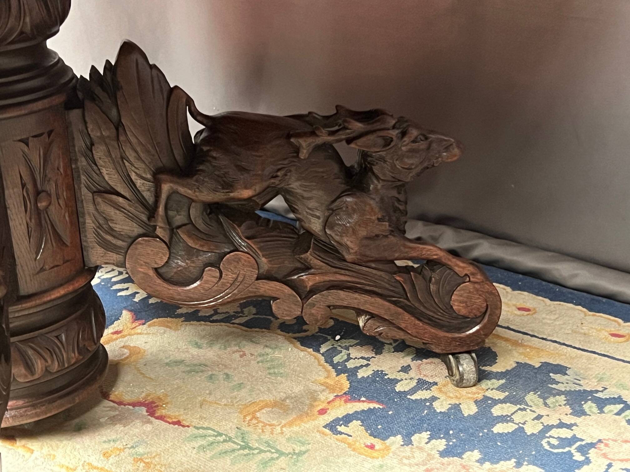 Hunting style dining table with figures of four different animals.
