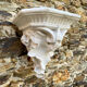 Antique wall console in patinated white plaster.
