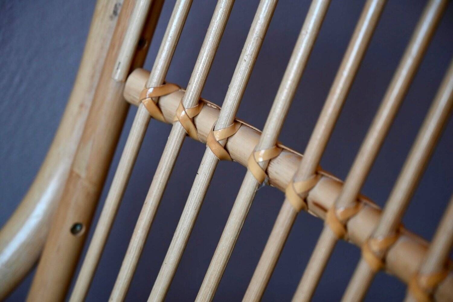Vintage rocking chair in rattan from the 60s-70s, high openwork backrest.