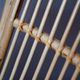 Vintage rocking chair in rattan from the 60s-70s, high openwork backrest.