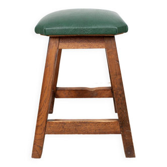 Old low stool, in wood and imitation leather.